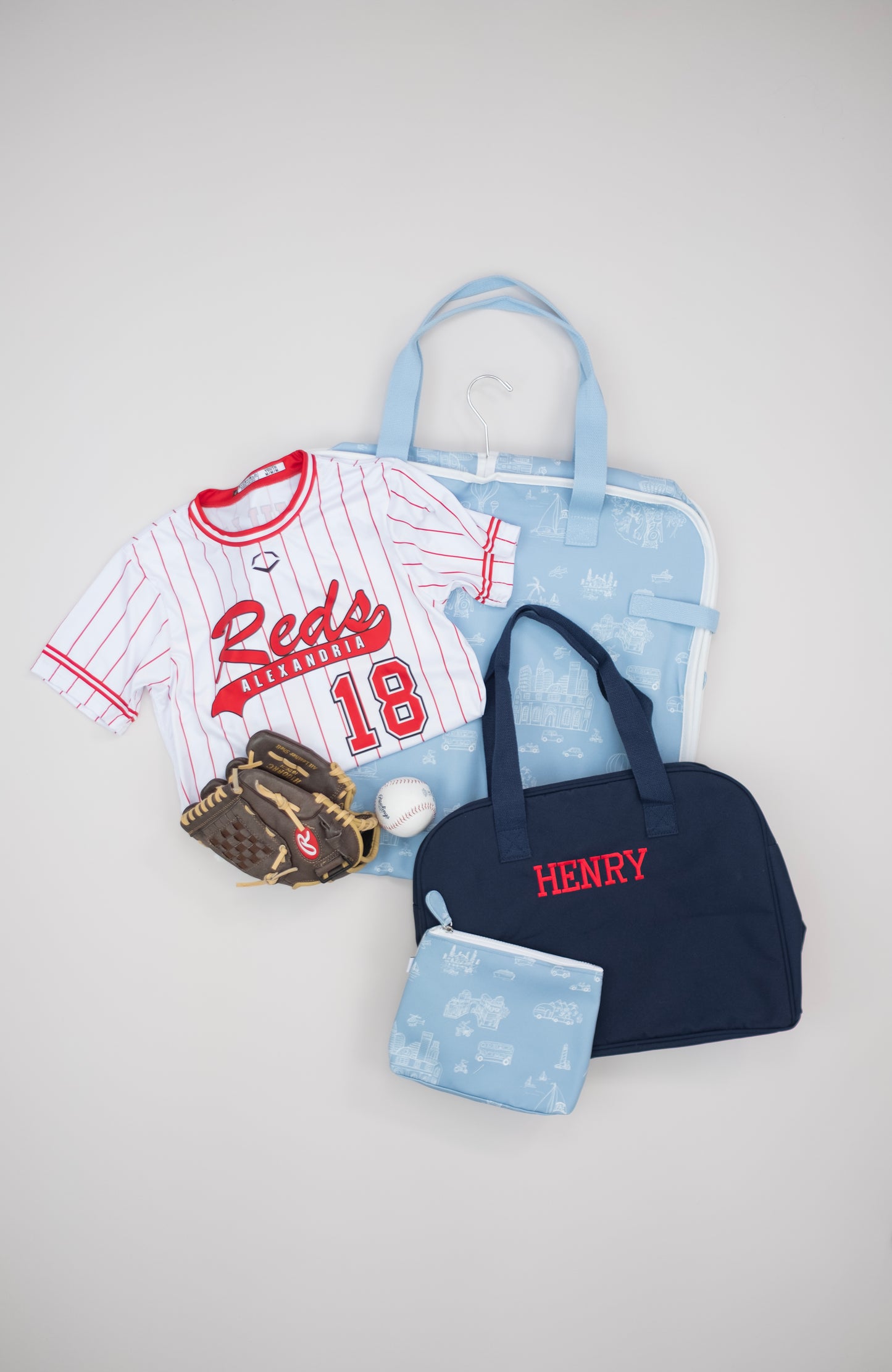 Baseball-themed items including a jersey, glove, and relevant Bitty Green packing set on a light gray background