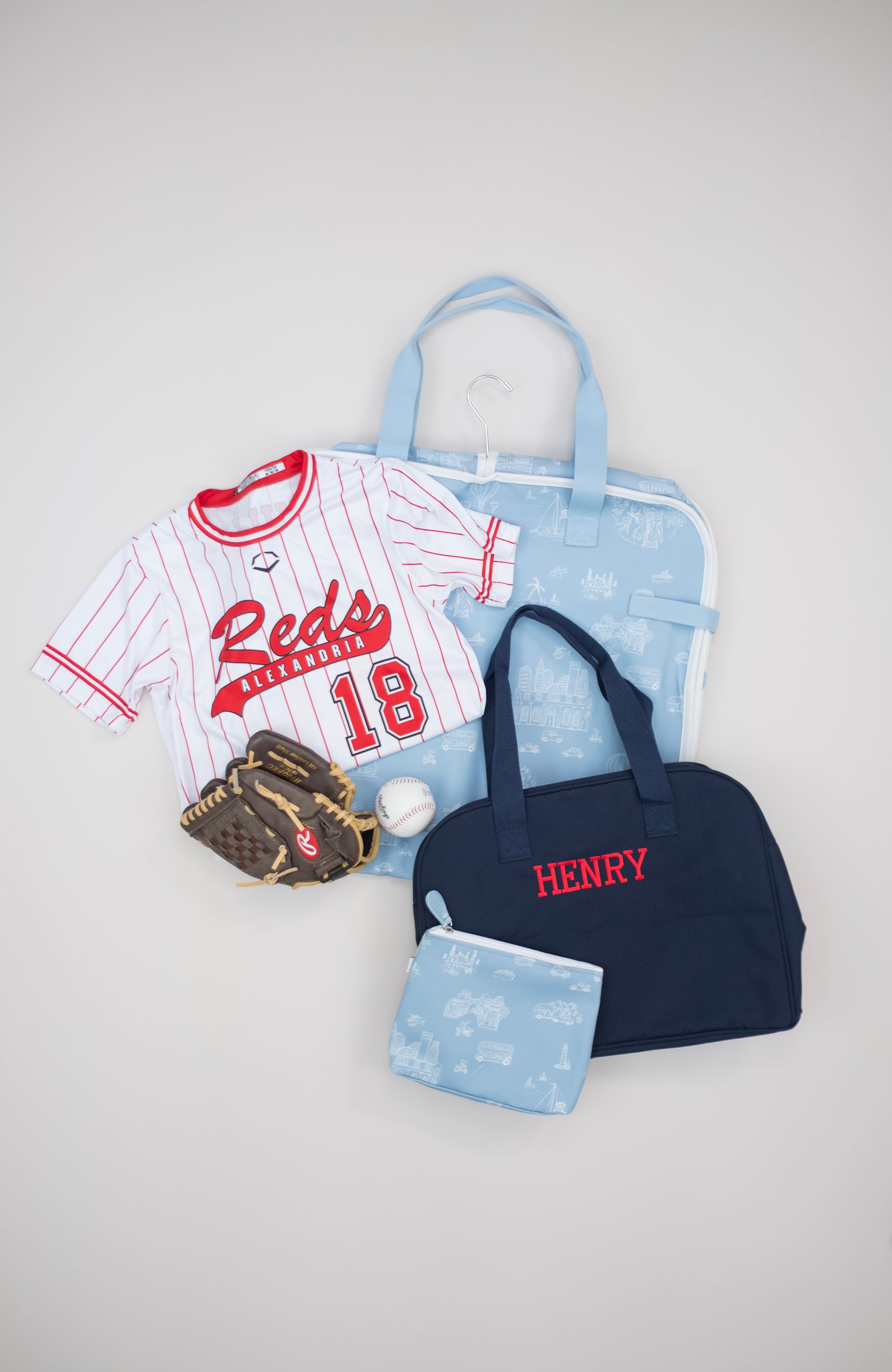 Baseball-themed items including a jersey, glove, and relevant Bitty Green packing set on a light gray background