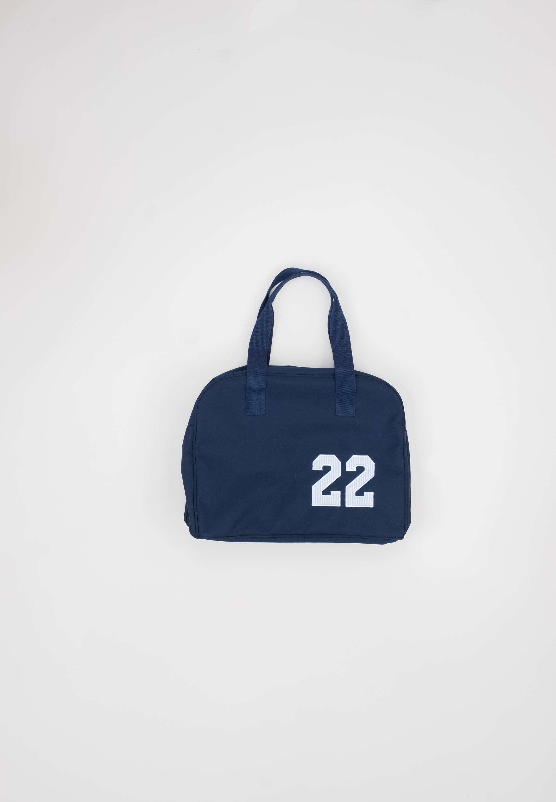 Navy blue bag with the number 22  to show personalization options, on a light gray background