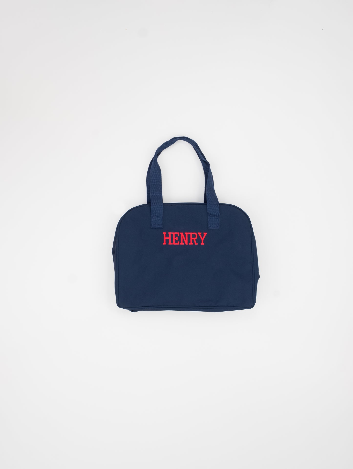 Navy blue bag with 'HENRY' embroidered on a white background