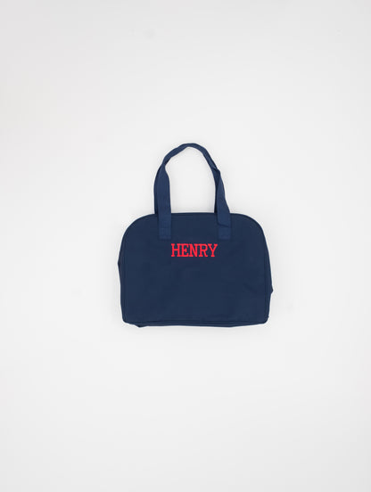 Navy blue bag with 'HENRY' embroidered on a white background