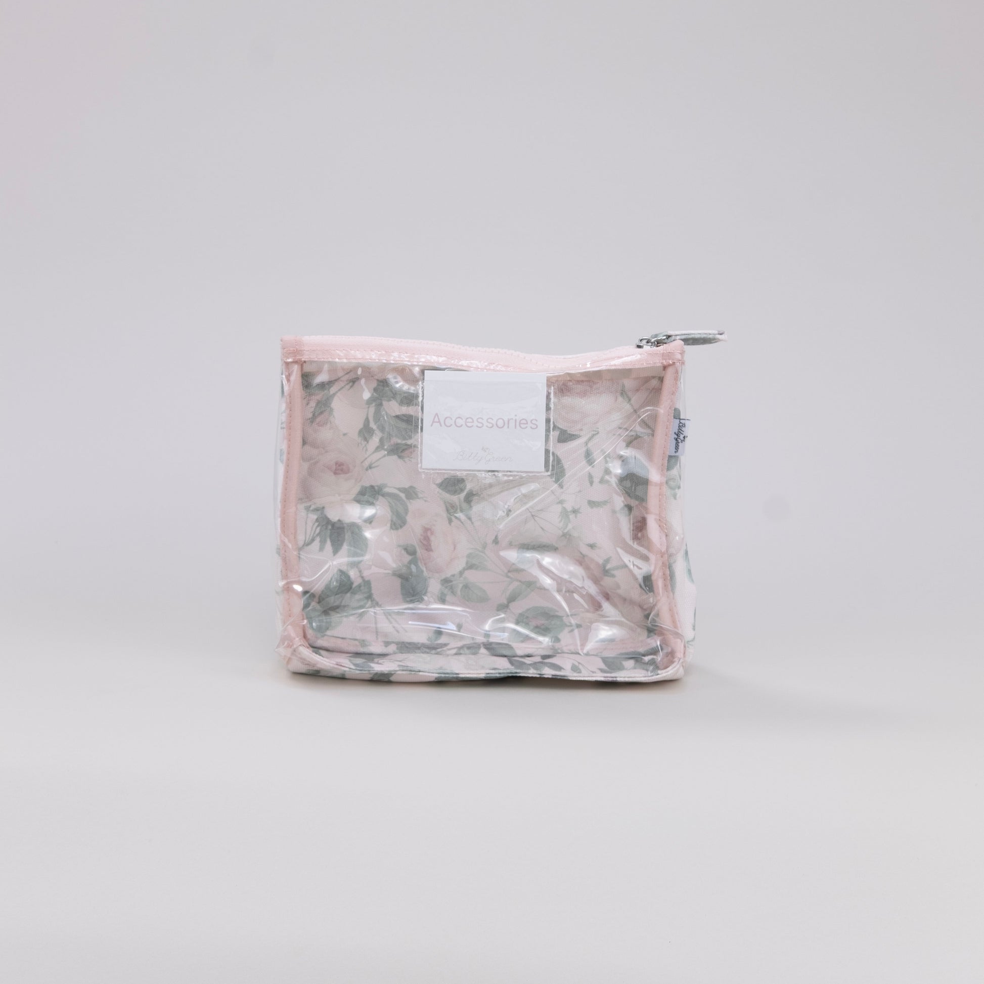 Clear plastic toiletry bag with a floral pattern on a light gray background